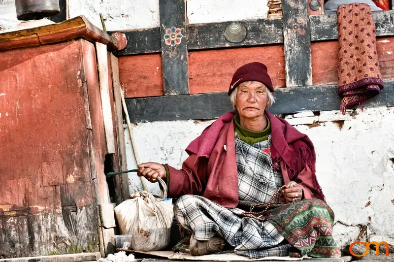 Bhutanese Woman Turning a Prayer Wheel