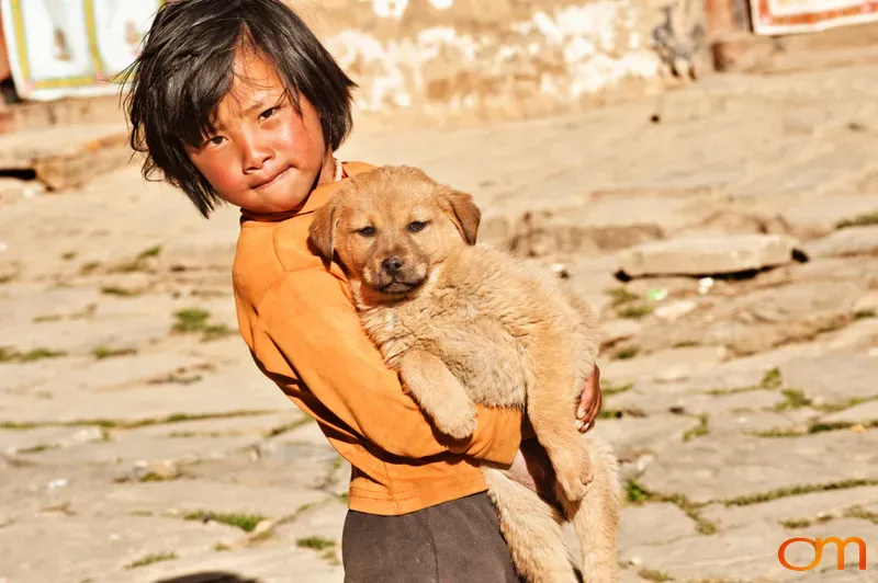 Child with Puppy in Bhutan