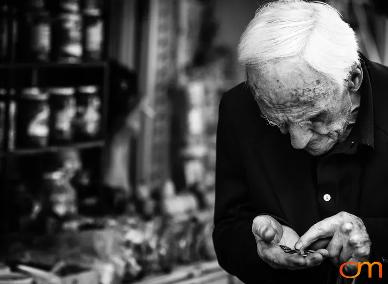 Elderly Man Counting Coins