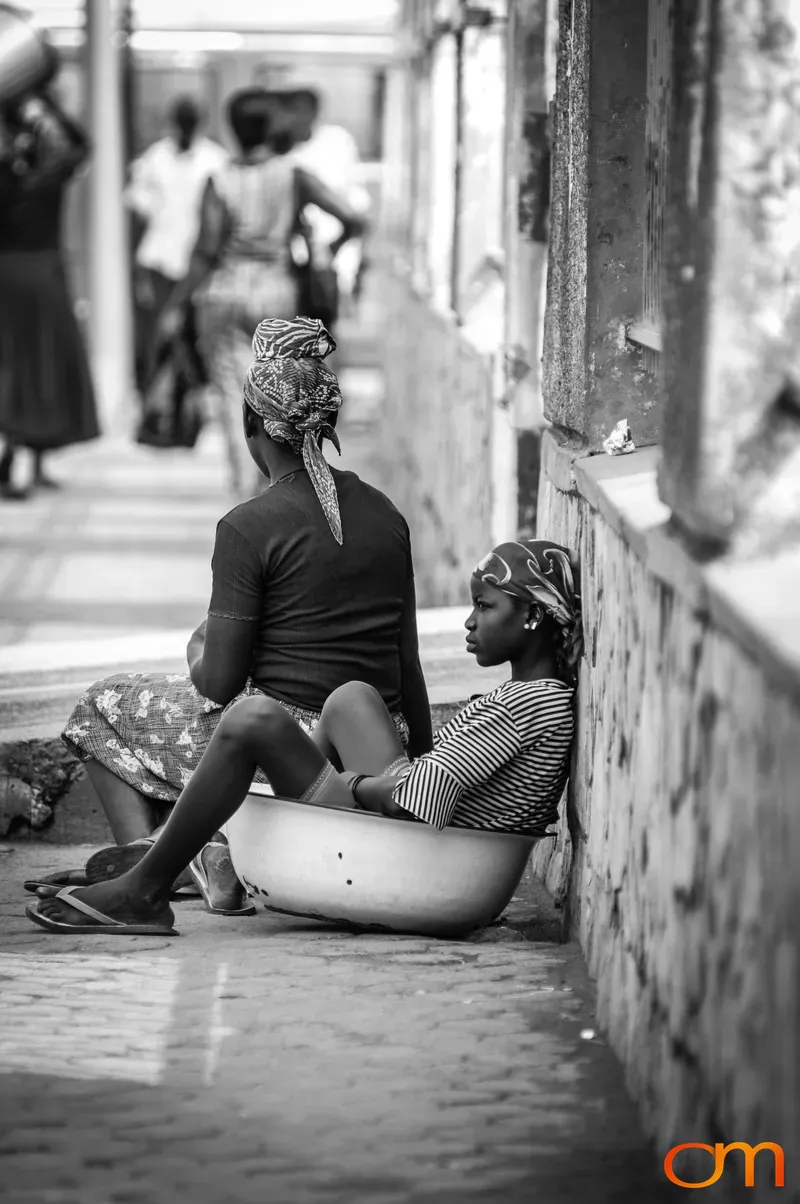 Women Resting on Sidewalk