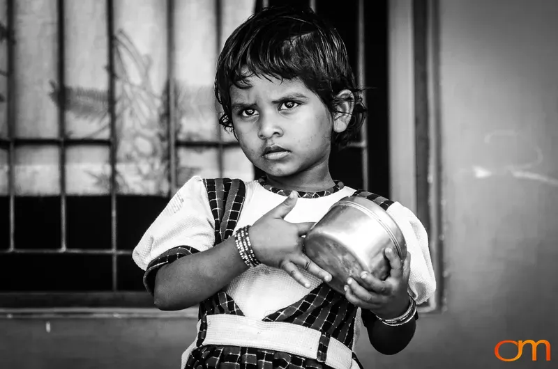 Young Girl Holding Metal Lunch Container