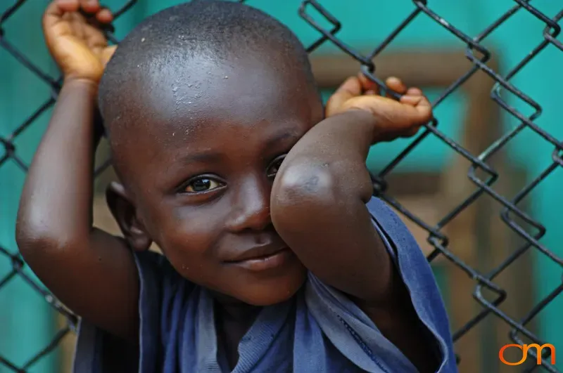 Portrait of Young Child Holding Fence
