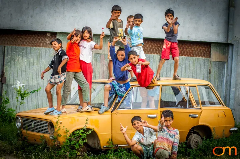 Children Playing on Abandoned Car