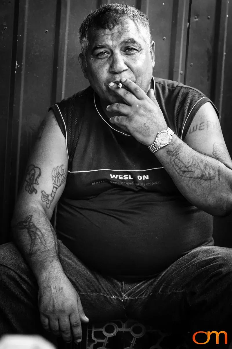 Tattooed Man Smoking in Šuto Orizari