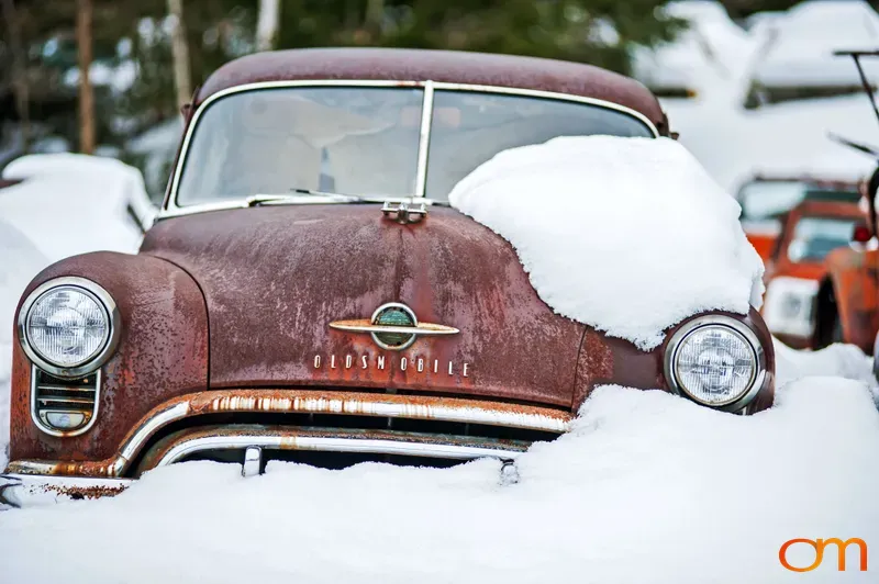 Vintage Oldsmobile Buried in Snow