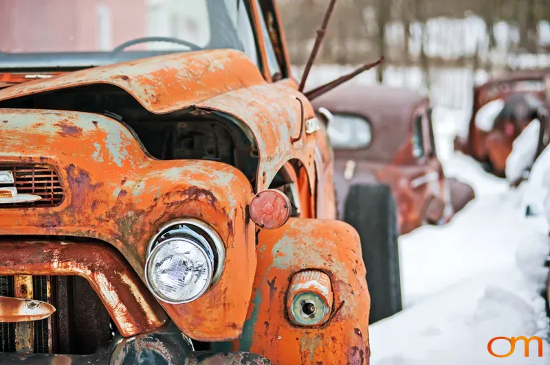 Rusted Orange Pickup Truck in Snow